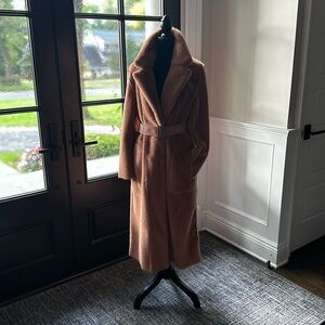 Beautiful faux fur apricot colored coat with vegan leather belt.